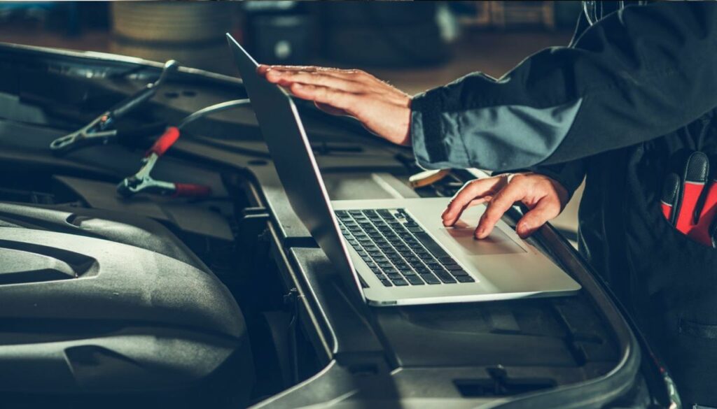 car diagnostic test by mechanic with a laptop